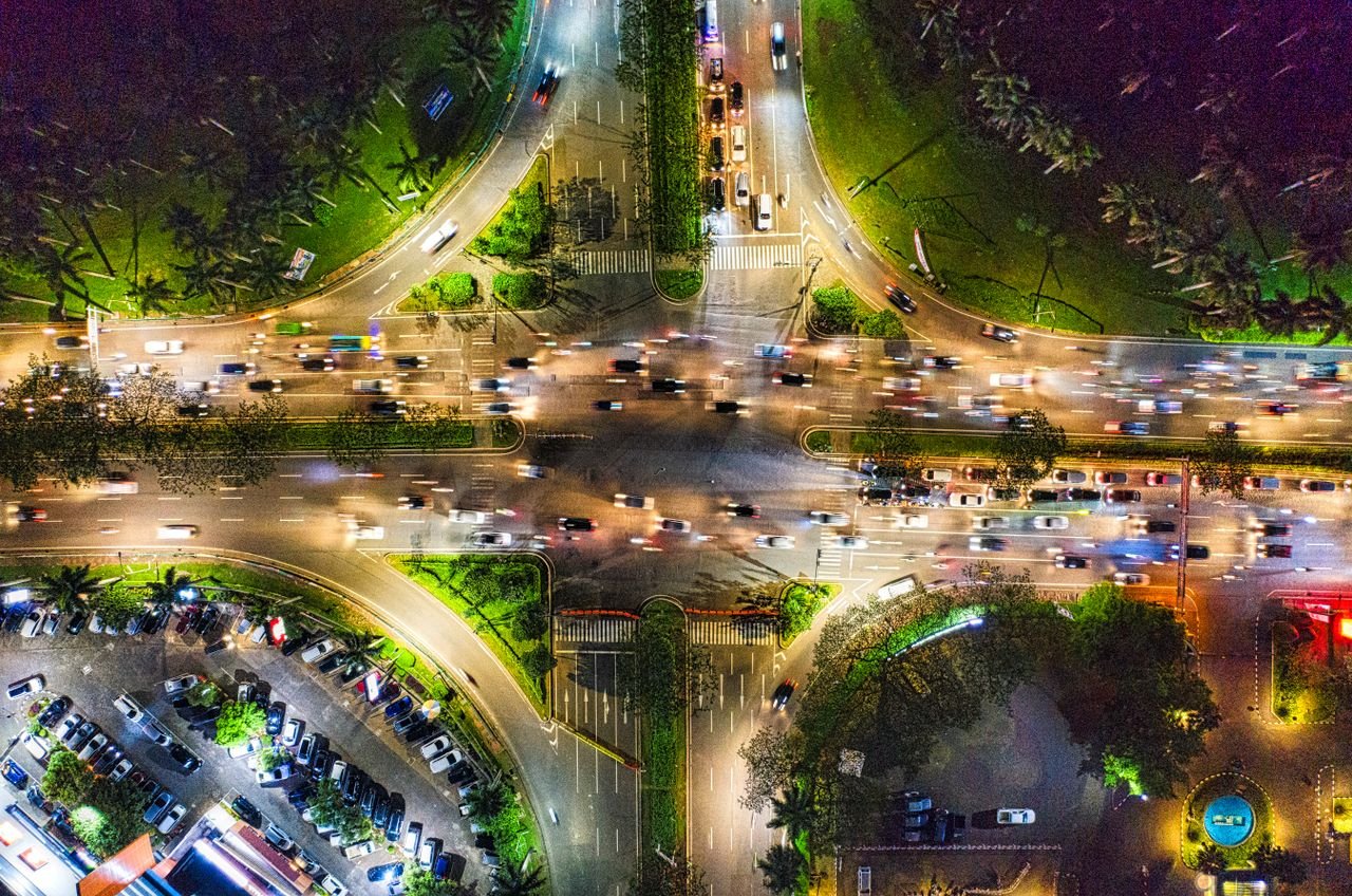 Vibrant aerial photo showcasing Banten's bustling intersection at night.